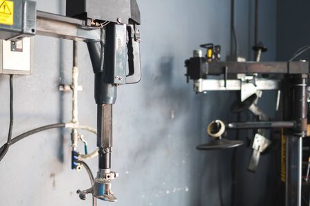 Mechanic removes car tire closeup. Machine for removing rubber from the wheel discの写真素材