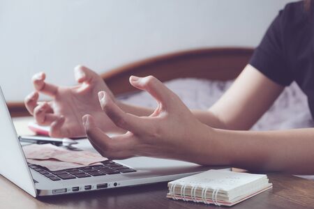 Angry woman in front of laptop during workingの写真素材