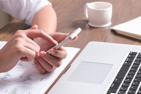 Business woman using smart phone during working time in office