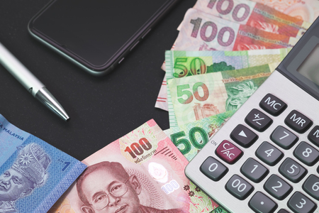 Financial,Banker,Investment, Business concept. Asia bank notes, Calculator on working deskの写真素材