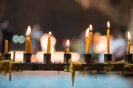 Yellow candle in Buddhism templeの写真素材