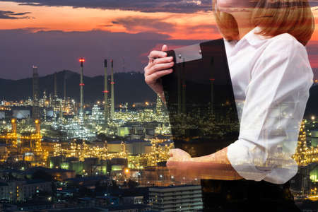 Double exposure of business woman in industry scene