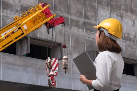 Female engineer wearing safety helmet in construction siteの写真素材