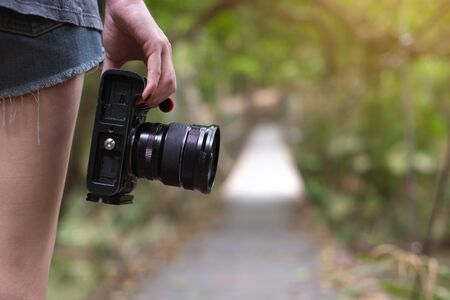 Camera on hand, Photographer in natureの写真素材