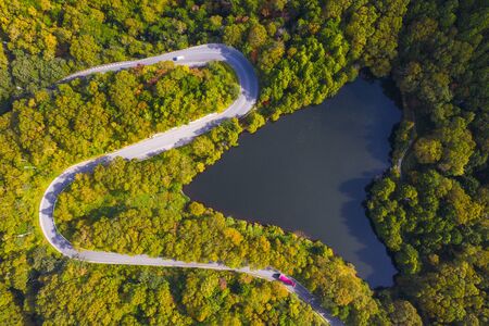 Aerial view of winding road on mountain in Autumnの写真素材