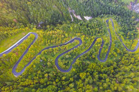 Aerial view of winding road on mountain in Autumnの写真素材