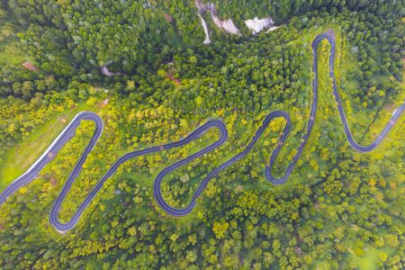 Aerial view of winding road on mountain in Autumnの写真素材