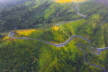 Aerial view of winding road on mountain in Autumnの写真素材