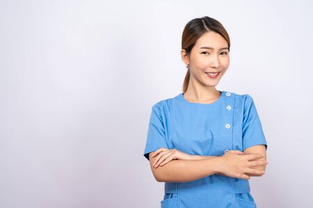 Portrait of young asian nurse on white backgroundの写真素材