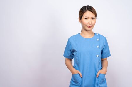 Portrait of young asian nurse on white backgroundの写真素材