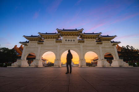 Young man traveller standing in front of National Chiang Kai-shek Memorial Hall , Taipei, Taiwan