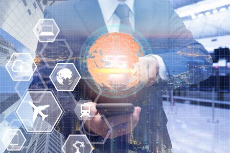 5G technology and global communication concept, Businessman using smart phone with technology icon, network, connection, internet in modern cityの写真素材