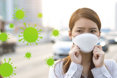 Air pollution and Virus spreading concept, Young woman wearing mask to prevent toxic and virus in cityの写真素材