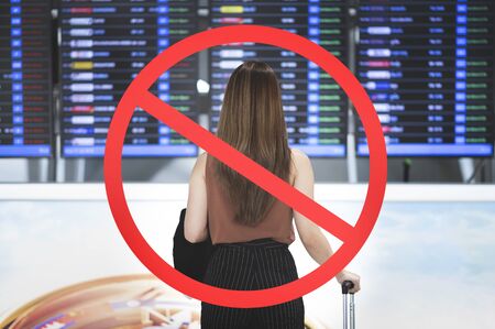 Stop travel in virus outbreak and trip-cancellation concept, Young woman carrying luggage with ignore iconの写真素材