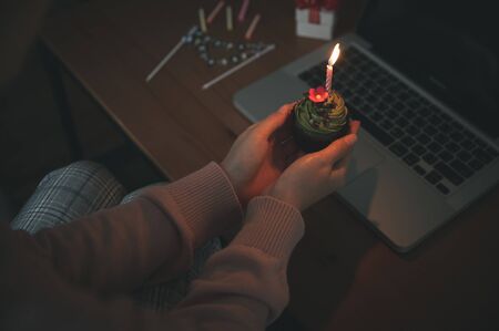 Asian woman celebrating colleague birthday through video call online virtual party at home while...