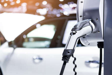 Electric vehicle charging port plugging in EV modern car. save ecology alternative energy sustainable of futureの写真素材
