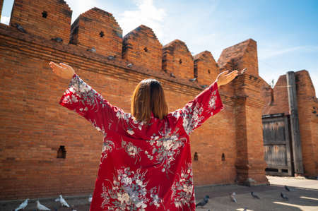 Asian woman traveling at Tha Phae Chiangmai old city wall in northern Thailandの写真素材