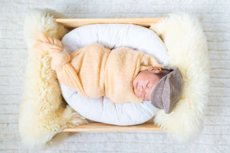 Newborn baby in costume sleeping in baby caseの写真素材