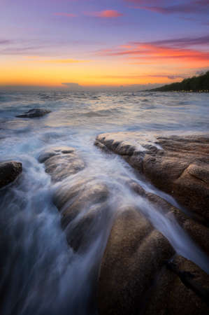 Seascape at sunset taken with long exposure to created slow movement of waveの写真素材