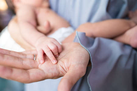 Baby hand in mother hand concept of love and Happiness of maternityの写真素材