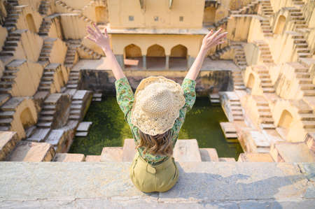 A young woman in India step-well at Jaipur in Rajasthan state, Indiaの写真素材