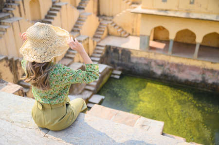 A young woman  in India step-well at Jaipur in Rajasthan state, Indiaの写真素材