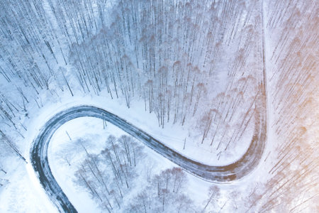 Top view of snow road shot from droneの写真素材