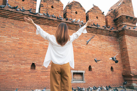 Asian woman traveling at the city wall tha pae gate landmark in Chiang Mai Thailandの写真素材