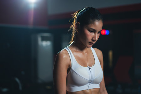 Asian sportswoman feeling tired or disappointed for failure training.の写真素材
