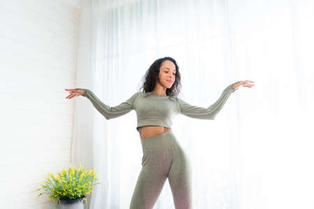 Beautiful young woman doing yoga at home. Healthy lifestyle concept.の写真素材