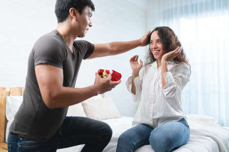 Young asian couple celebrating valentine's day together at homeの写真素材