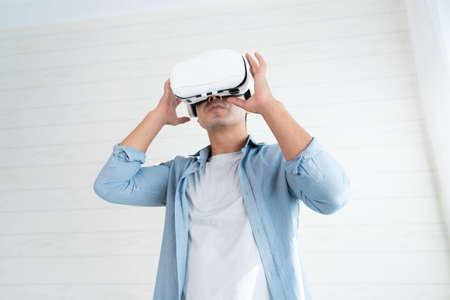 Young man wearing virtual reality goggles, vr box or 3d glassesの写真素材