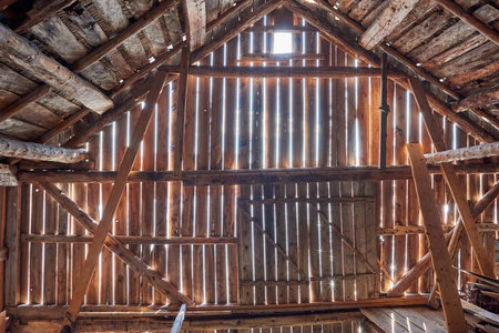 Old barn with sun shining from outsideの写真素材