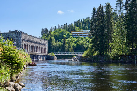 A river beneath a hydroelectric power plant building.の写真素材