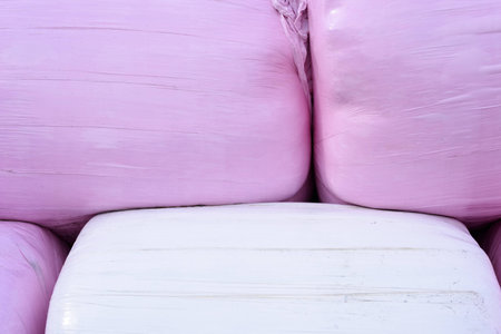 Bales of hay in pink and plastic wrapping.の写真素材