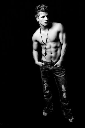 young muscular man with christian signの写真素材