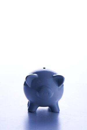 blue plain piggy bank on isolated white backgroundの写真素材