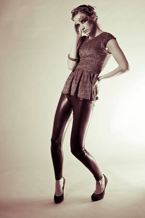 dark hair model with nice make-up wearing black legins in sepia , Fashion shoot in the studioの写真素材
