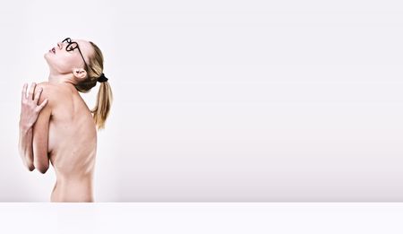 anorectic nude model wearing glasses on isolated white background , space for advertの写真素材