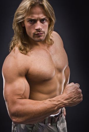 Sexy topless  muscular man isolated on blackの写真素材