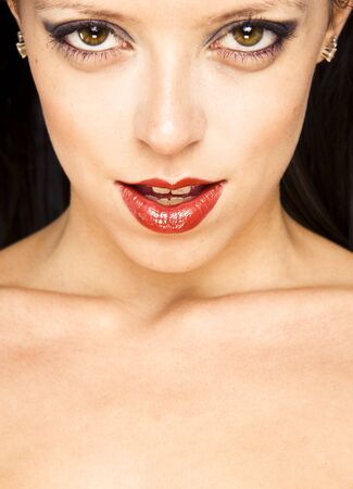  Close-up portrait of a beautiful woman with red lips .Warm yellow tones.の写真素材
