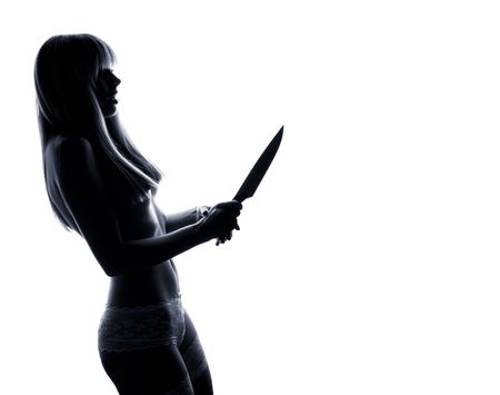 charm nude woman in low-key holding the nife on white background の写真素材