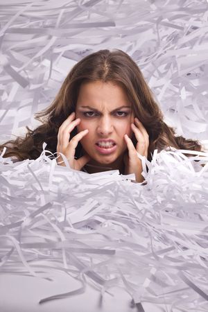 Young Businesswoman covered by shredded papersの写真素材