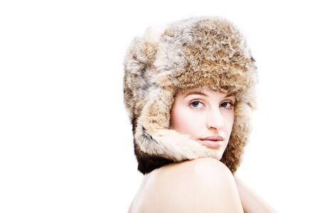 portrait of a beautiful girl in a fur russian hatの写真素材