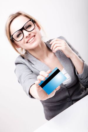 a young business woman holding new credit cardの写真素材