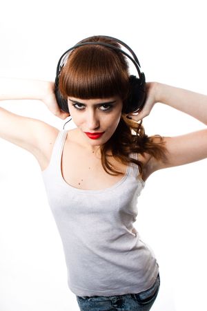 A beautiful young woman with headphones listening musicの写真素材