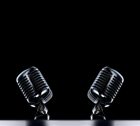 two Retro Mic's stage background in black with space for text の写真素材