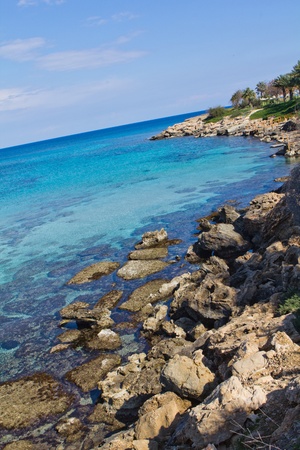 Rocky coast, blue sea and sky.の写真素材