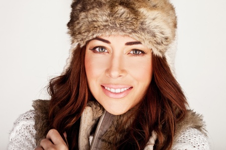 Stunning Redhead In Winter Fur Hat with subtle make-up and lovely smile.の写真素材