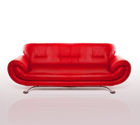 Modern stylish couch with arms and a metal frame upholstered in red leather, studio over whiteの写真素材